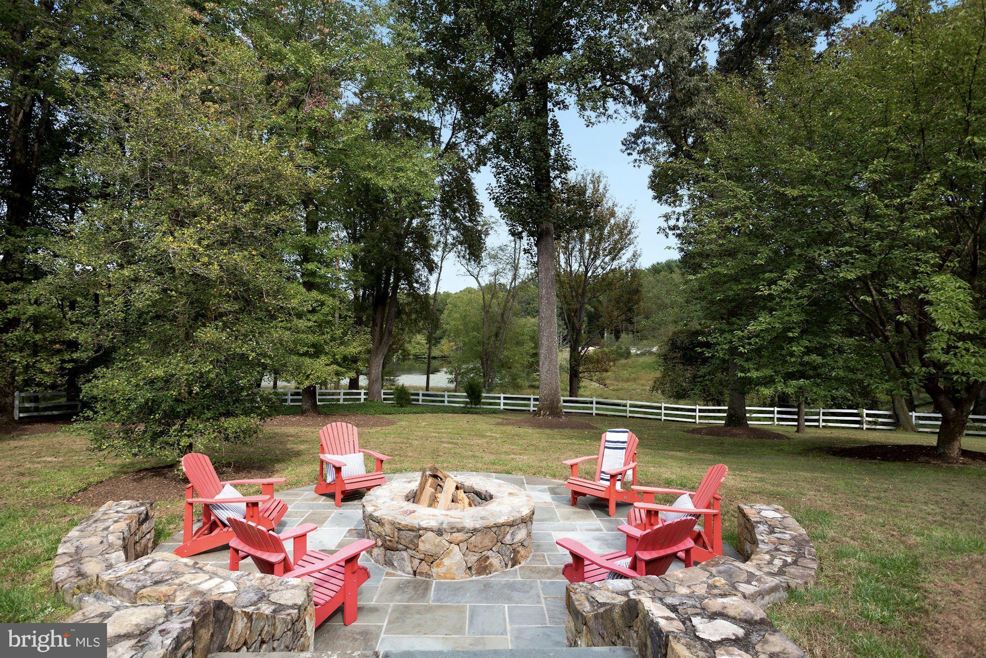 337 Springvale Road Great Falls, VA 22066 - Photo 96 of 120 a backyard of a house with fire pit and outdoor seating