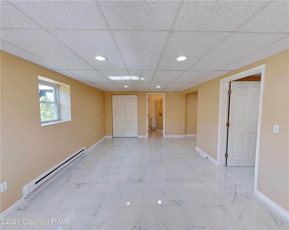 1110 Misty Ridge East Stroudsburg, PA 18302 - Photo 38 of 43 A versatile open-concept space features resilient tile flooring and clean lines, offering boundless possibilities.