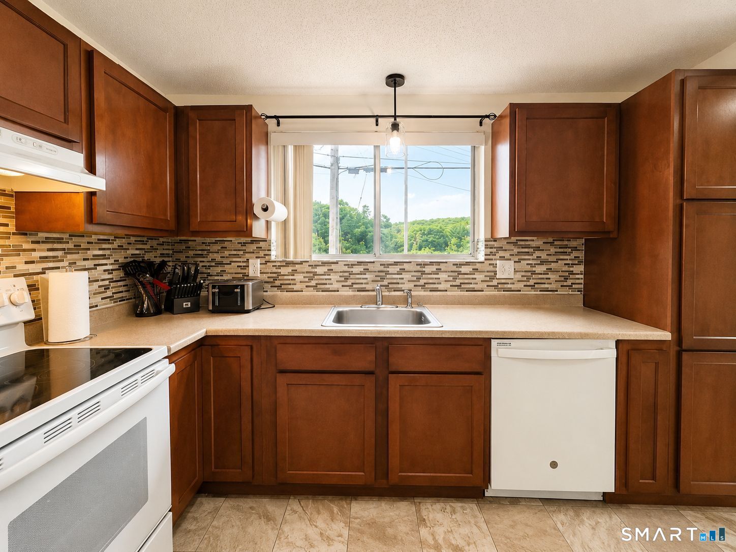 461 Spring Street, Unit 1A Naugatuck, CT 06770 - Photo 6 of 17 a kitchen with stainless steel appliances a sink stove and refrigerator