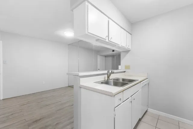 a kitchen with a sink and cabinets
