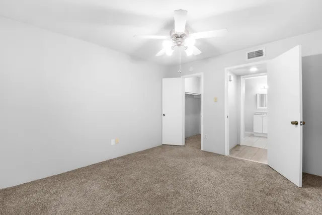 wooden floor in an empty room and a chandelier fan