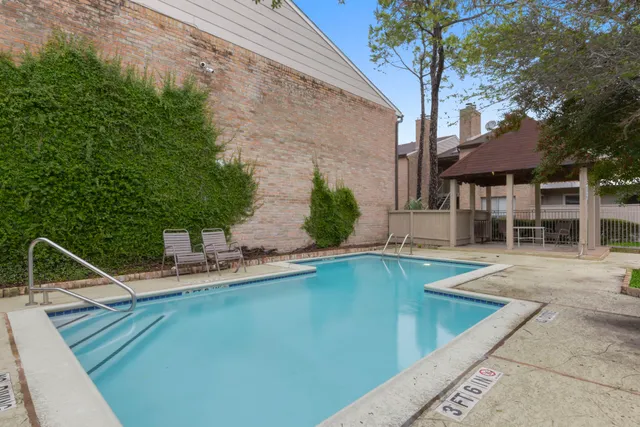 a view of a backyard with a patio and plants
