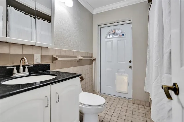 a bathroom with a granite countertop sink toilet and a mirror