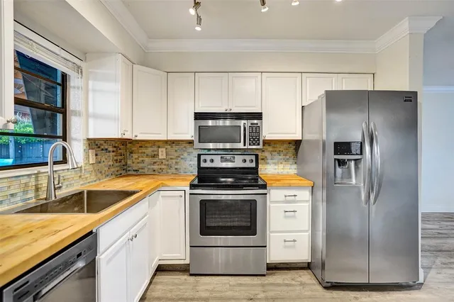 a kitchen with a stove refrigerator and cabinets