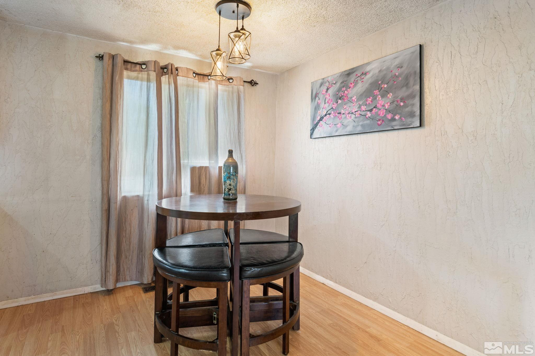 335 West Cedar Street Fernley, NV 89408 - Photo 11 of 26 a view of a room with furniture and wooden floor