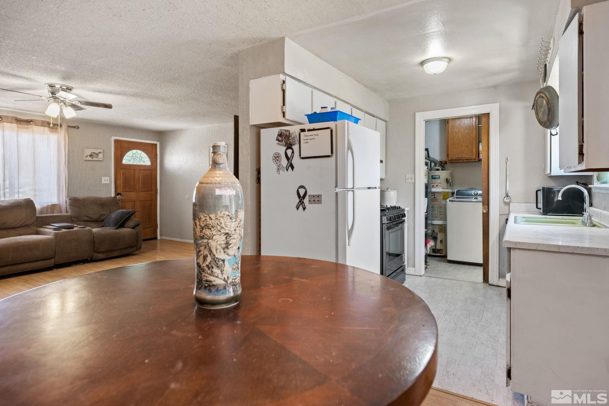 335 West Cedar Street Fernley, NV 89408 - Photo 12 of 26 a view of a kitchen with furniture and a chandelier