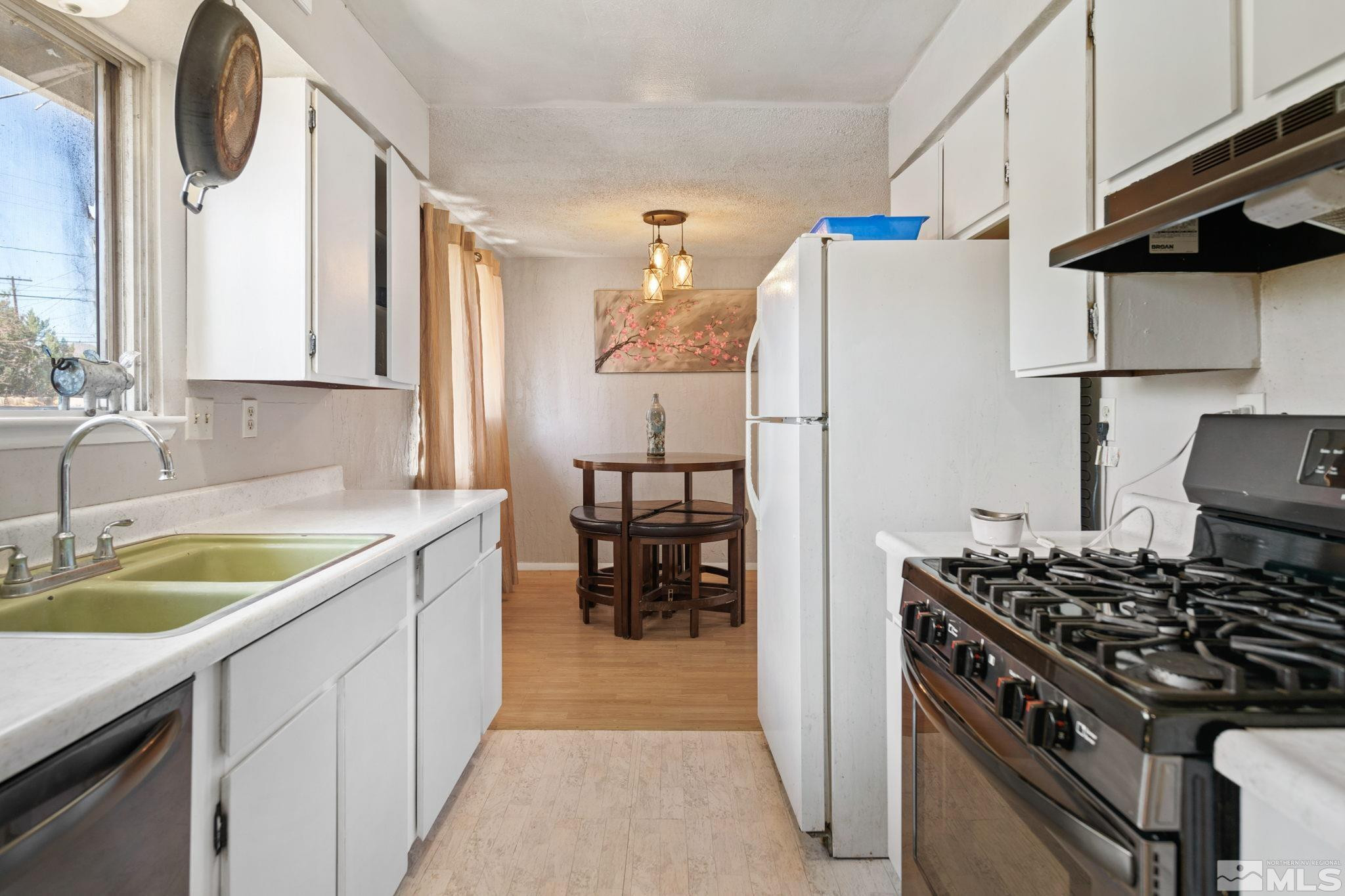 335 West Cedar Street Fernley, NV 89408 - Photo 15 of 26 a kitchen with a stove a sink and a refrigerator