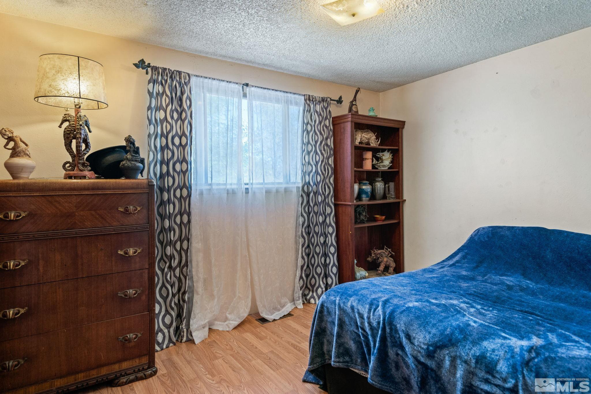 335 West Cedar Street Fernley, NV 89408 - Photo 19 of 26 a bedroom with a bed and closet