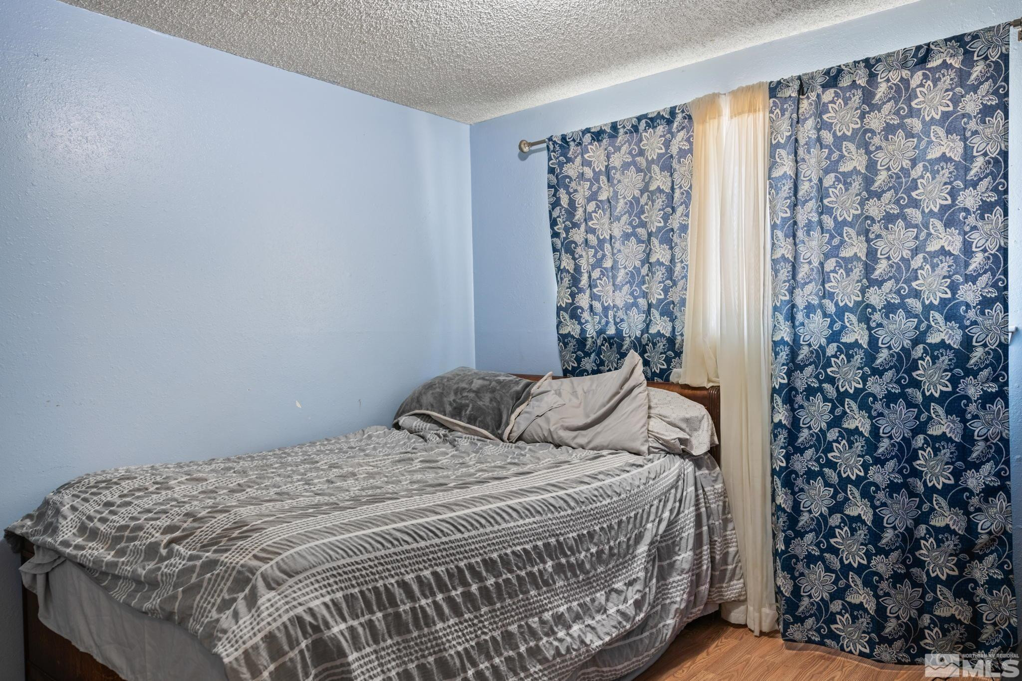 335 West Cedar Street Fernley, NV 89408 - Photo 20 of 26 a bedroom with a bed and a curtain