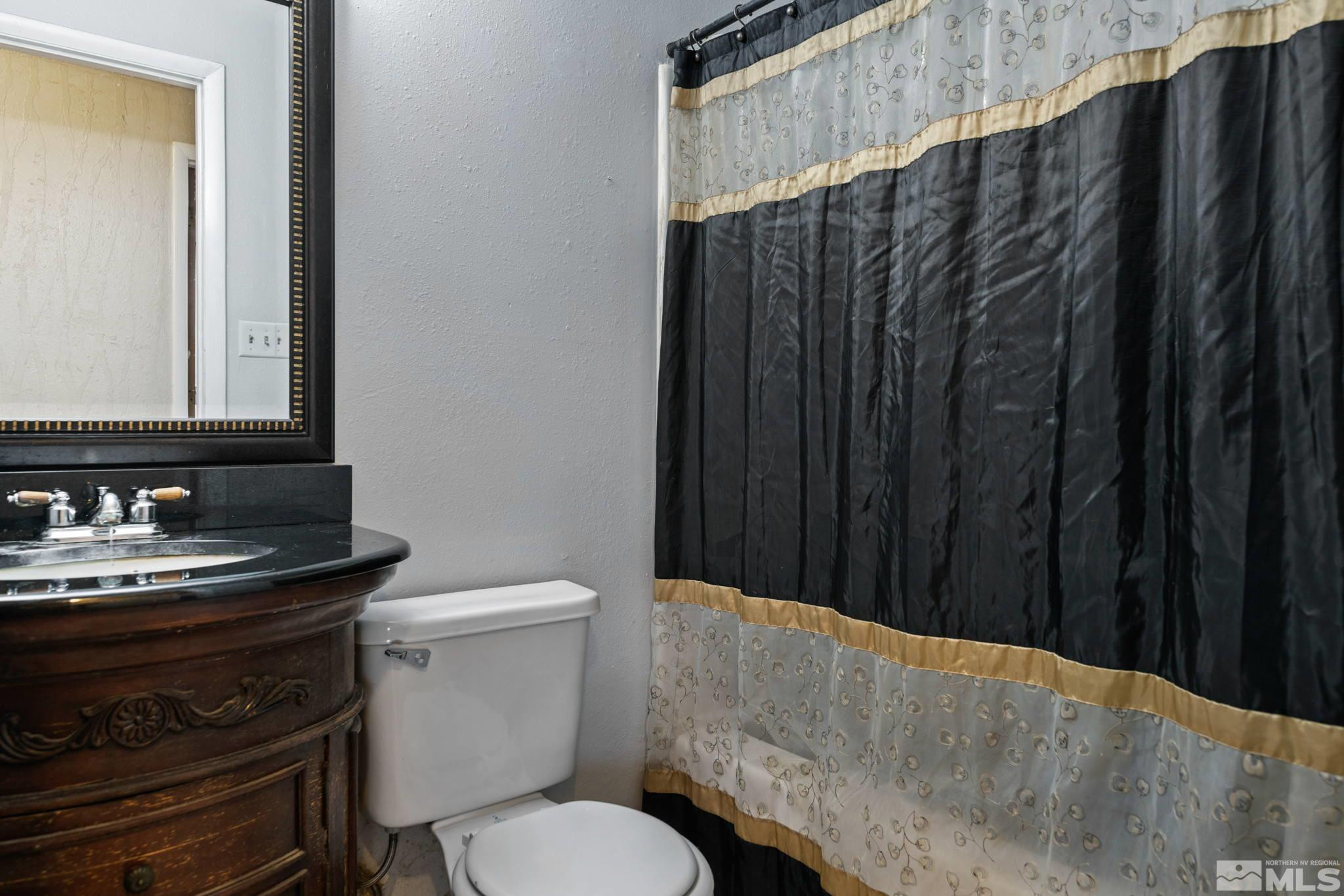 335 West Cedar Street Fernley, NV 89408 - Photo 21 of 26 a bathroom with a toilet and a sink