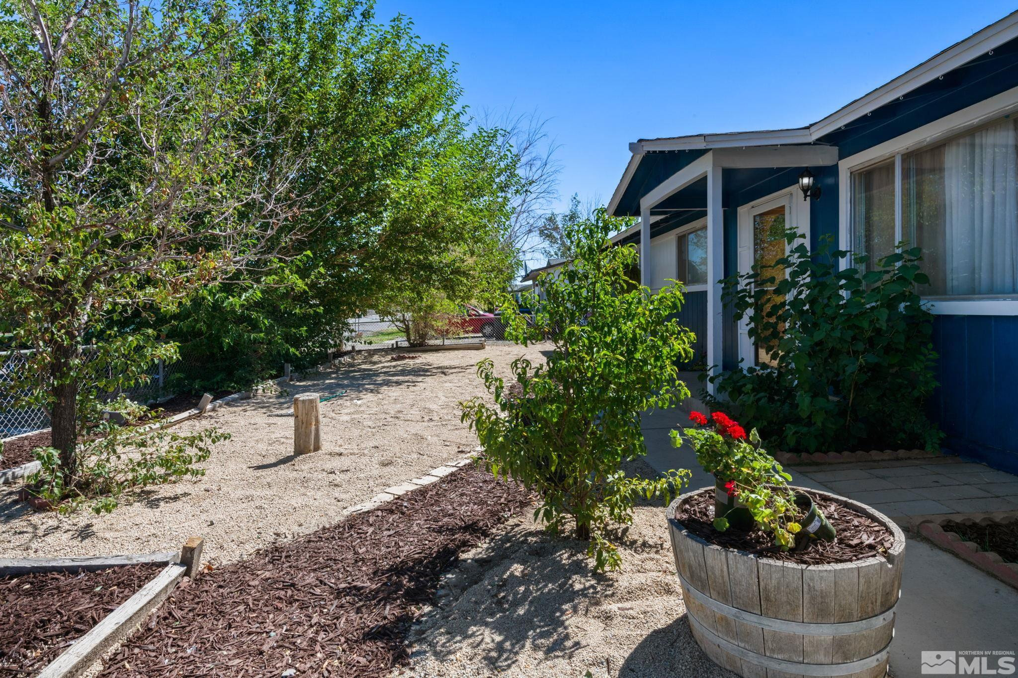 335 West Cedar Street Fernley, NV 89408 - Photo 4 of 26 a view of a house with a yard and potted plants