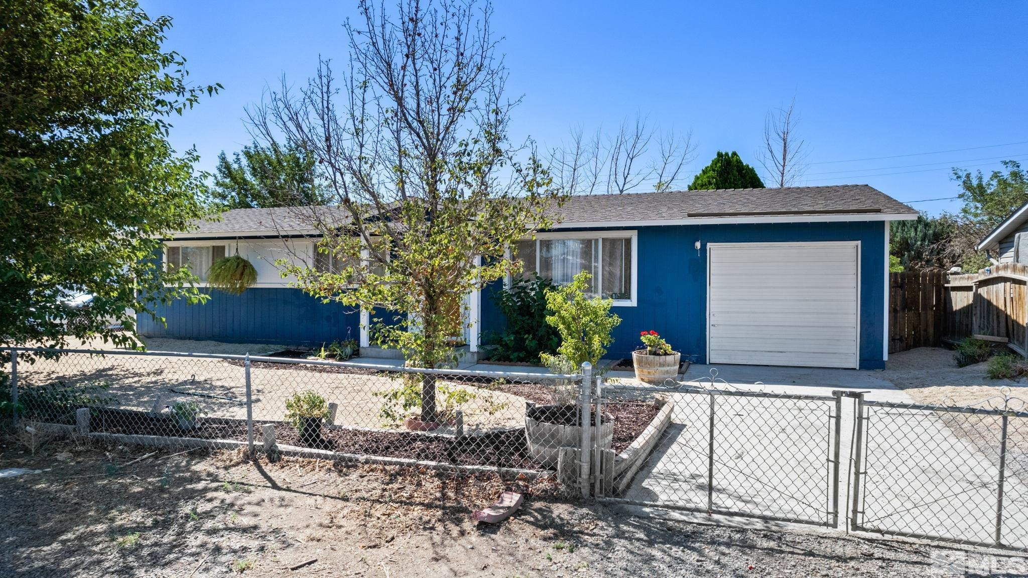 335 West Cedar Street Fernley, NV 89408 - Photo 7 of 26 a front view of house with yard nad seating space
