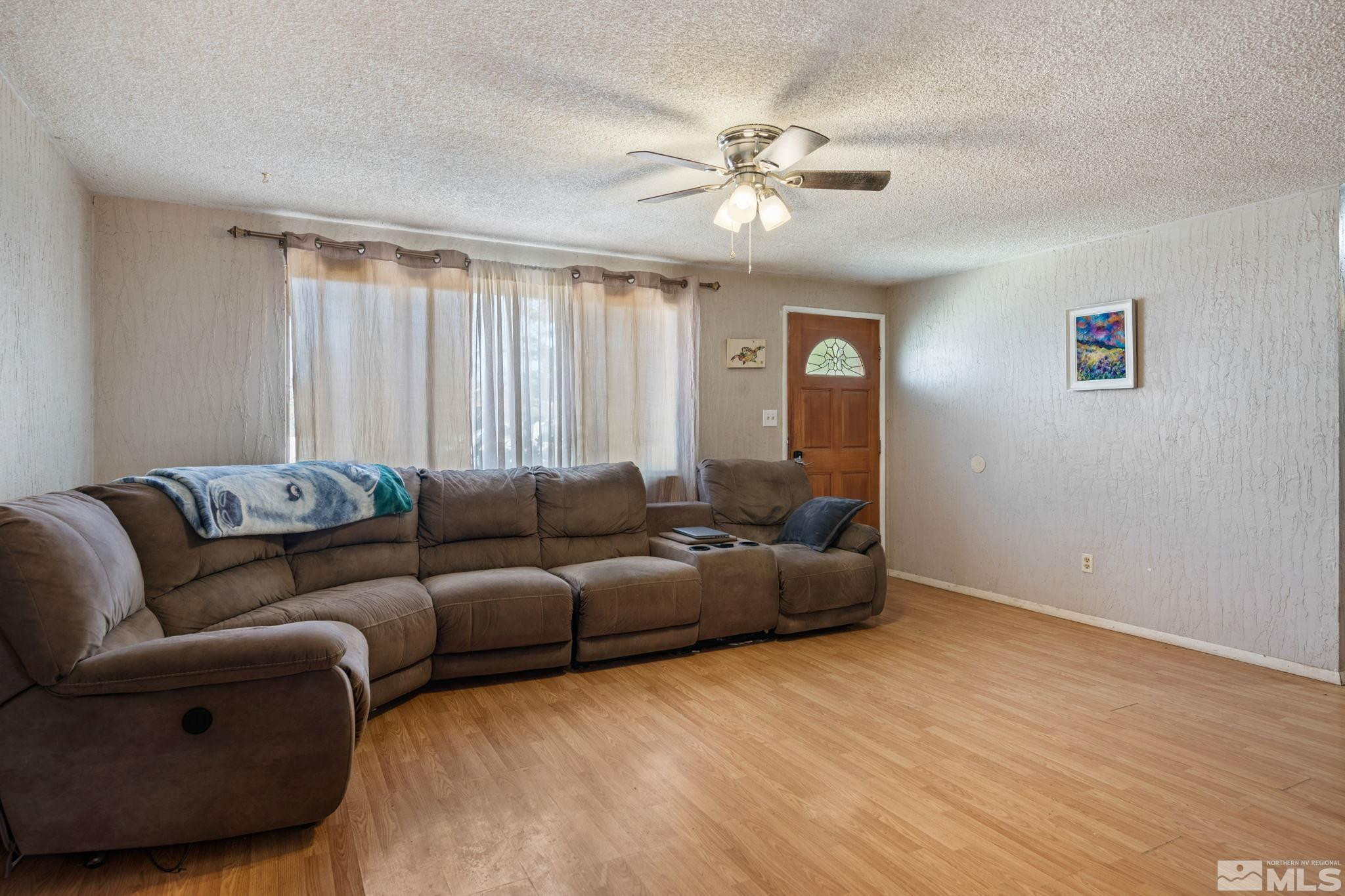 335 West Cedar Street Fernley, NV 89408 - Photo 9 of 26 a living room with furniture and a large window