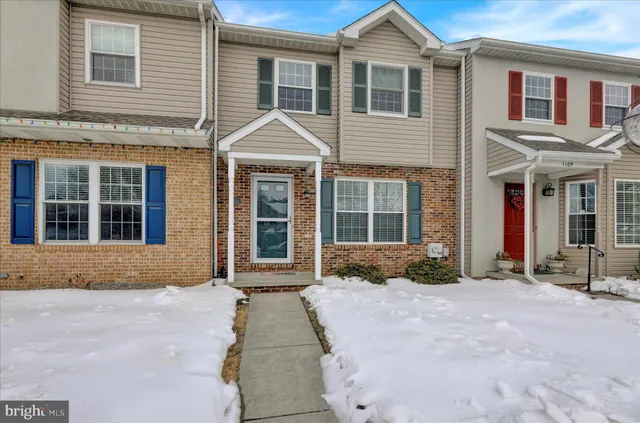 a front view of a house with a yard and glass windows