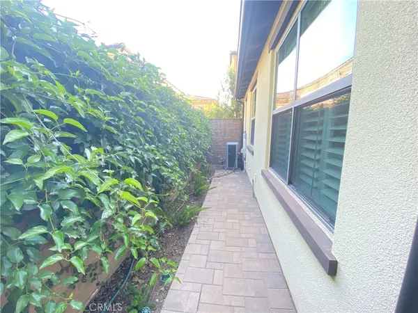 a view of a pathway both side of the house