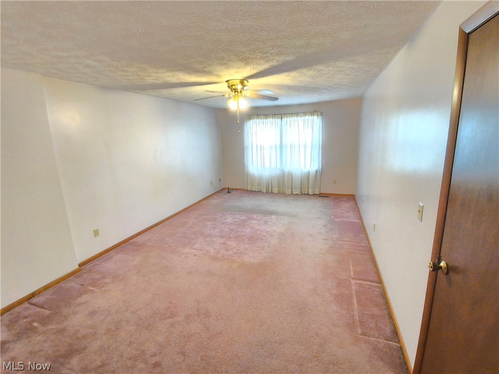 2672 Crackel Road Aurora, OH 44202 - Photo 22 of 38 Spare room with a textured ceiling, ceiling fan, and light colored carpet