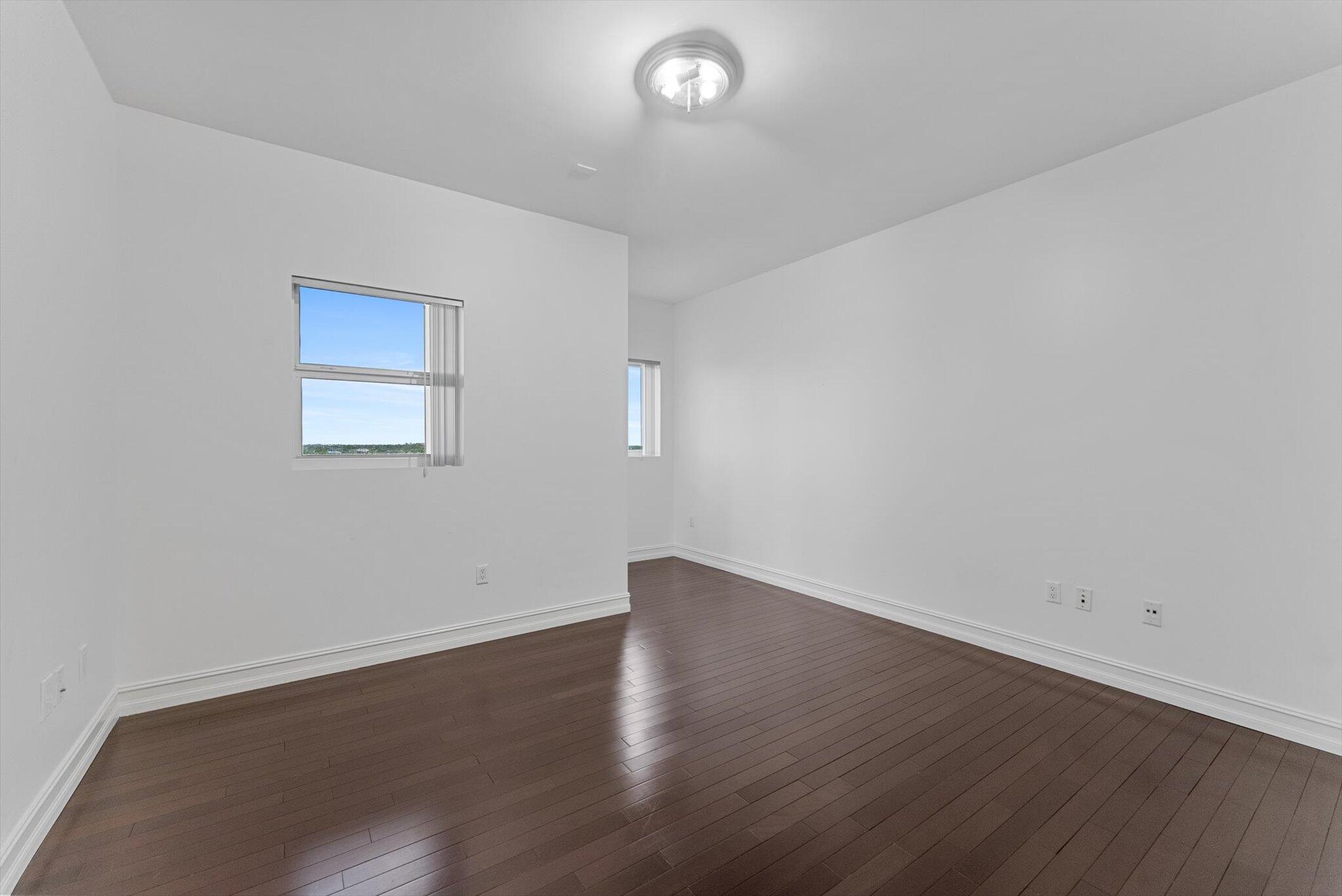 455 East Palmetto Park Road, Unit 6E Boca Raton, FL 33432 - Photo 15 of 28 an empty room with wooden floor and windows