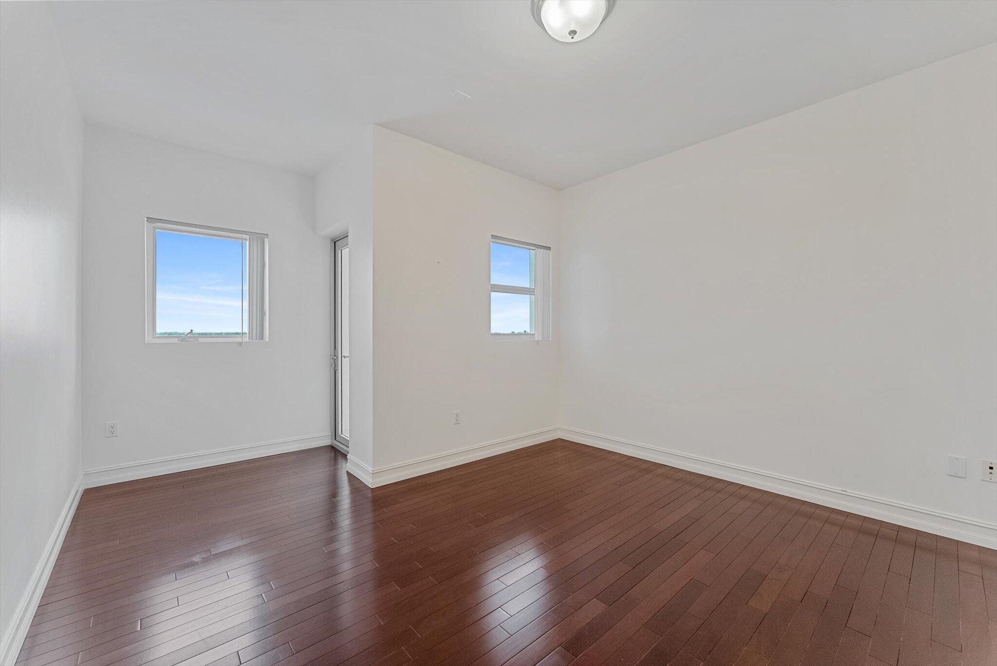 455 East Palmetto Park Road, Unit 6E Boca Raton, FL 33432 - Photo 21 of 28 a view of an empty room with wooden floor and a window