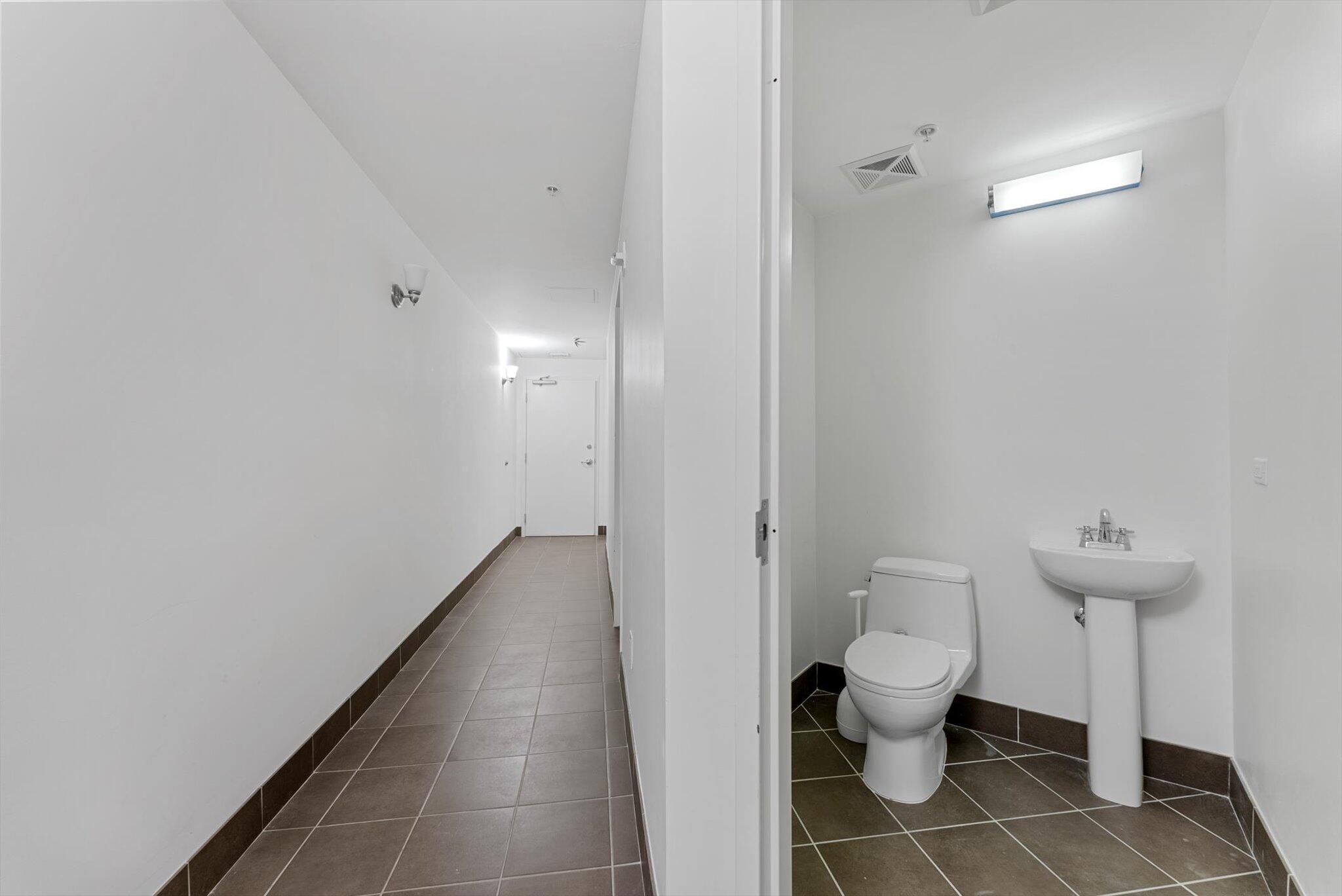 455 East Palmetto Park Road, Unit 6E Boca Raton, FL 33432 - Photo 23 of 28 a bathroom with a toilet and a mirror