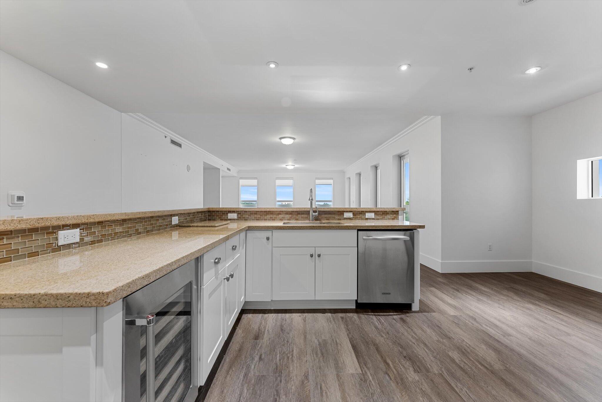 455 East Palmetto Park Road, Unit 6E Boca Raton, FL 33432 - Photo 5 of 28 a kitchen with sink cabinets and wooden floor