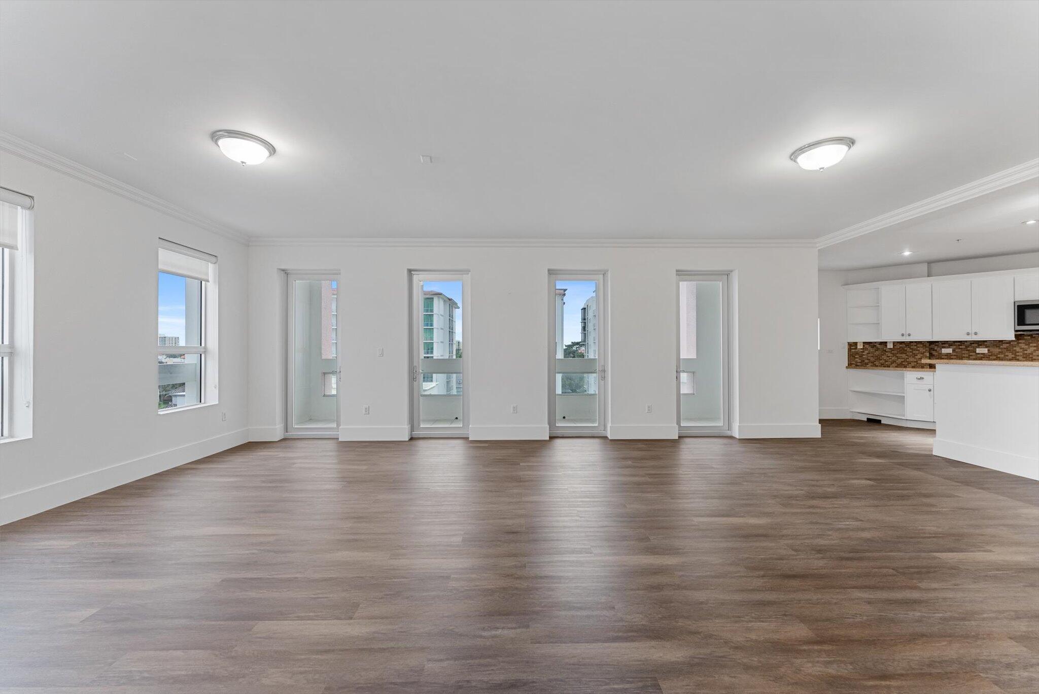 455 East Palmetto Park Road, Unit 6E Boca Raton, FL 33432 - Photo 8 of 28 a view of an empty room with window and wooden floor
