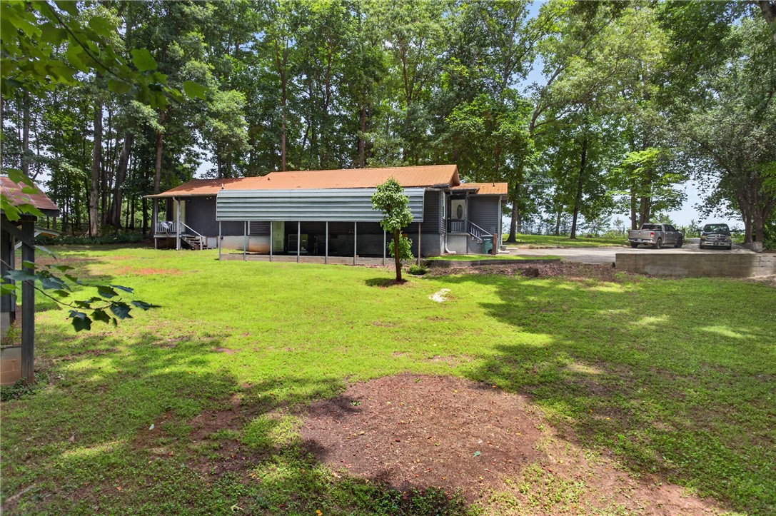 230 Dickard Road Seneca, SC 29672 - Photo 23 of 25 A private estate with a spacious lawn and mature trees surrounds a welcoming residence.