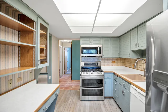 a kitchen with stainless steel appliances granite countertop a stove and a refrigerator