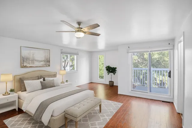 a bedroom with a large bed and a wooden floor