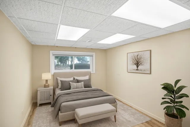 a bedroom with a bed and a painting on the wall