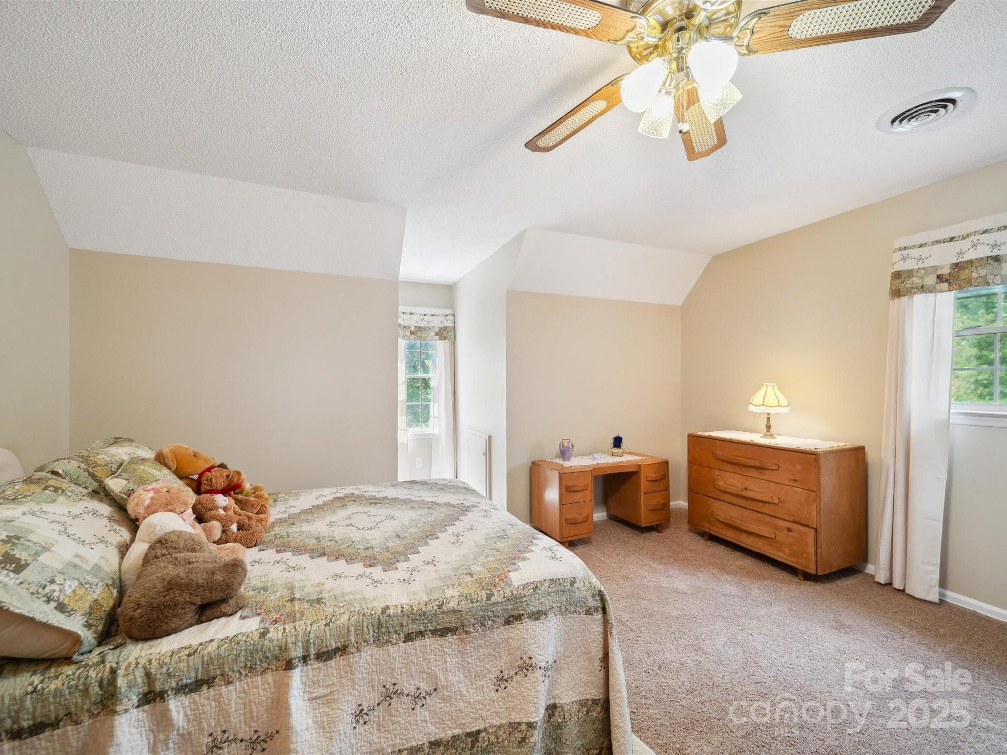 394 Gold Mine Road Wadesboro, NC 28170 - Photo 24 of 39 a bedroom with a bed and a chandelier