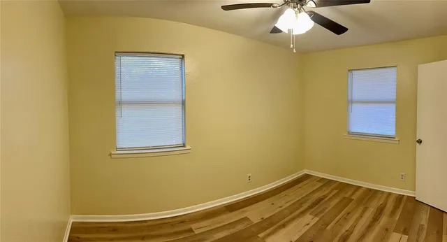a view of a room with a ceiling fan