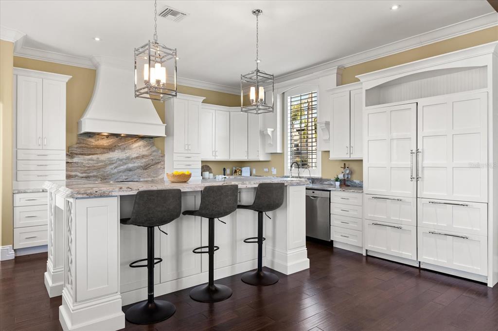 812 Stephens Pass Cove Lake Mary, FL 32746 - Photo 11 of 60 a kitchen with stainless steel appliances kitchen island granite countertop a stove a sink and a refrigerator