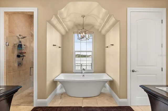 a living room with furniture a table and a chandelier