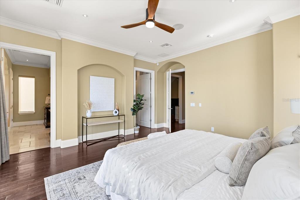 812 Stephens Pass Cove Lake Mary, FL 32746 - Photo 27 of 60 a bedroom with a large bed and a chandelier