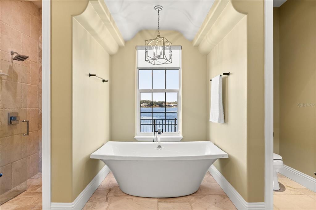 812 Stephens Pass Cove Lake Mary, FL 32746 - Photo 29 of 60 a white bath tub sitting in a bathroom next to a window