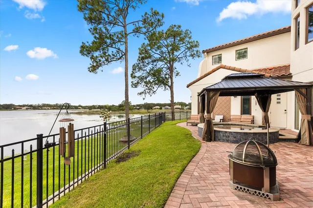 a view of house with garden space and lake view
