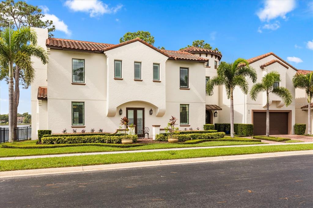 812 Stephens Pass Cove Lake Mary, FL 32746 - Photo 56 of 60 a front view of a house with a yard