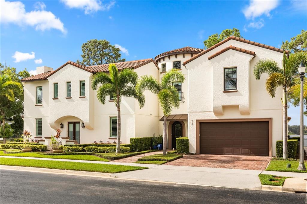 812 Stephens Pass Cove Lake Mary, FL 32746 - Photo 57 of 60 a front view of a house with a yard and garage