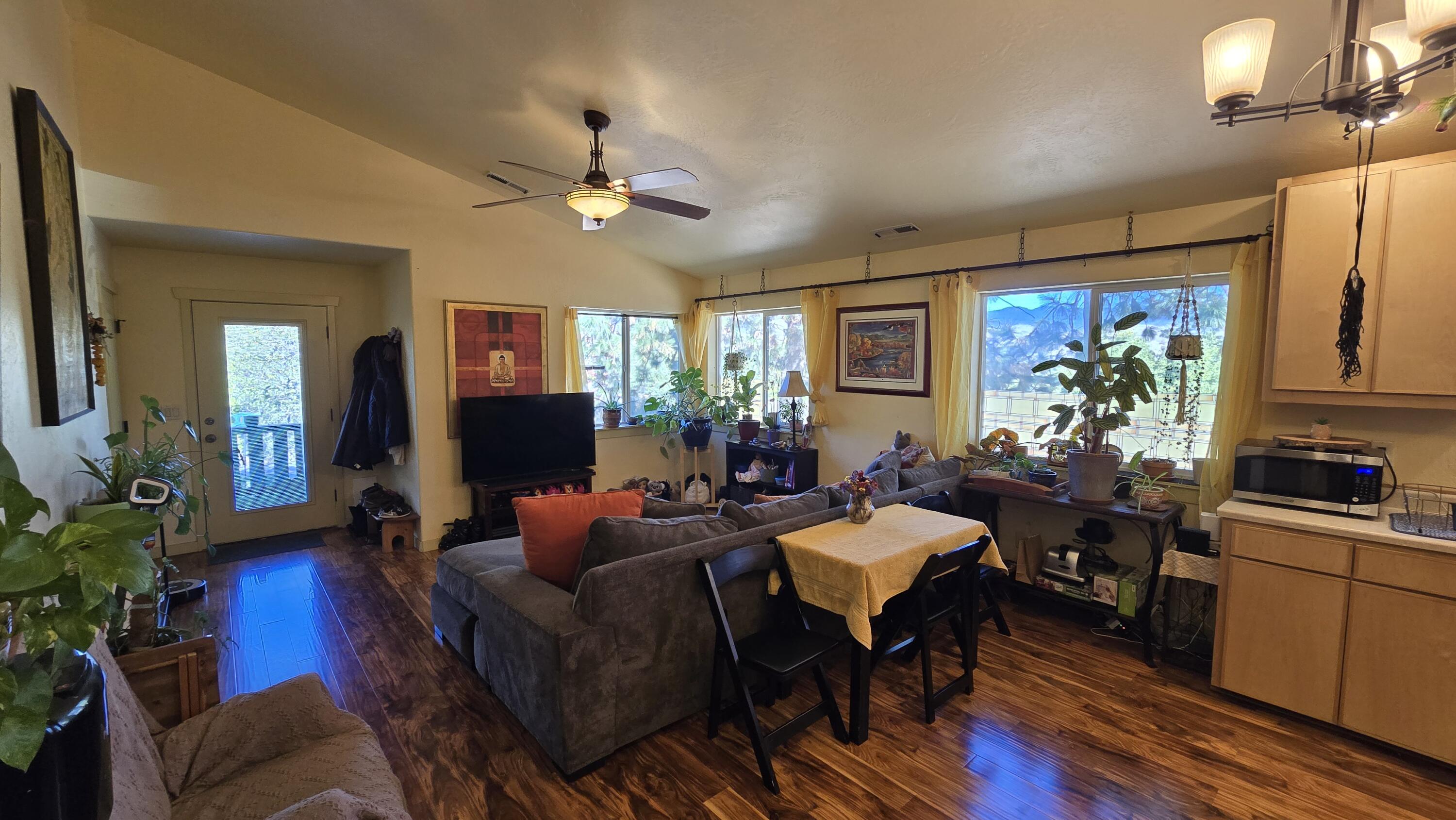 488 Crowson Road Ashland, OR 97520 - Photo 11 of 30 a living room with furniture a chandelier and a flat screen tv