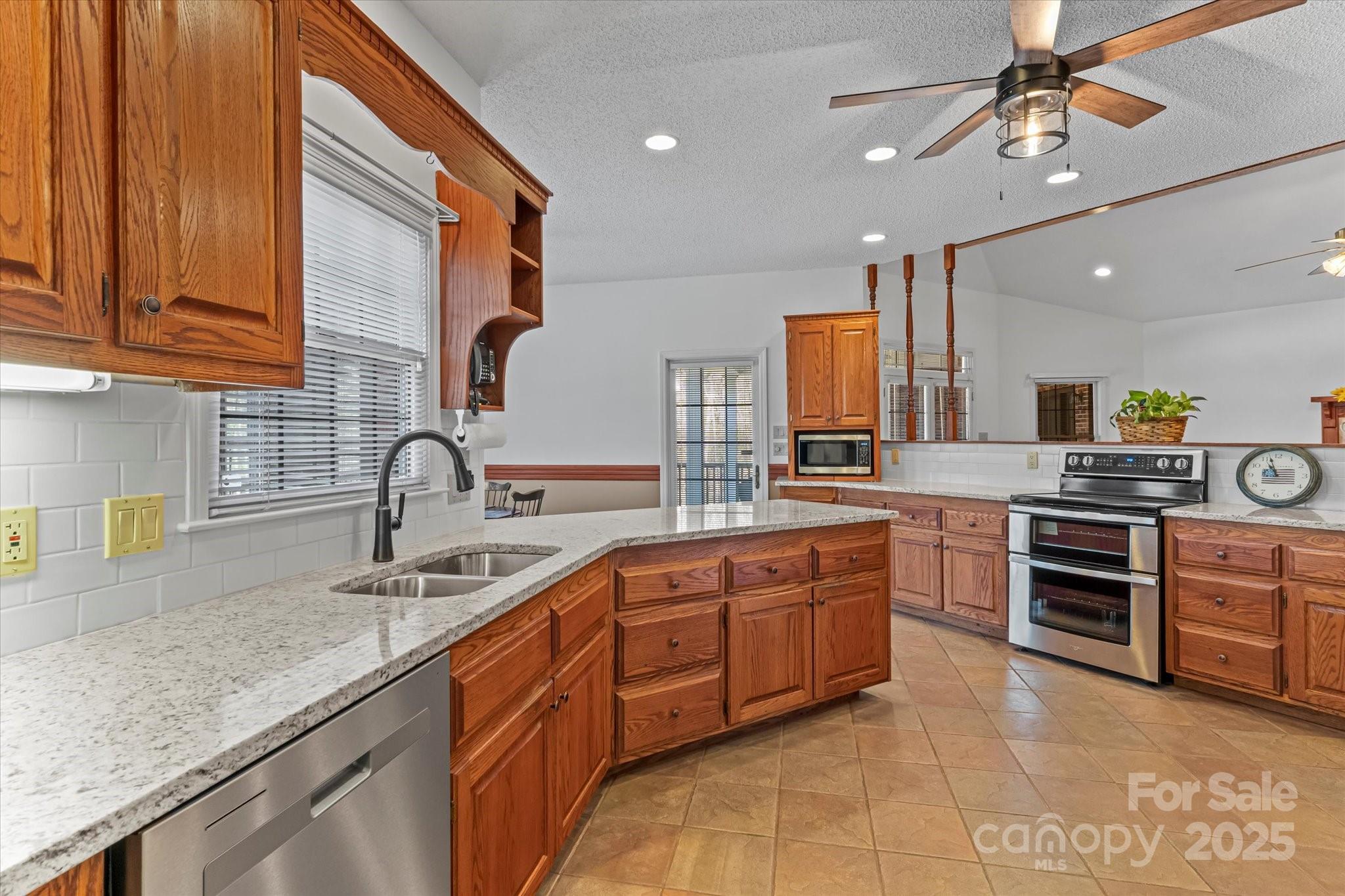 1030 Hurley School Road Salisbury, NC 28147 - Photo 12 of 48 a kitchen with stainless steel appliances granite countertop a sink and stove