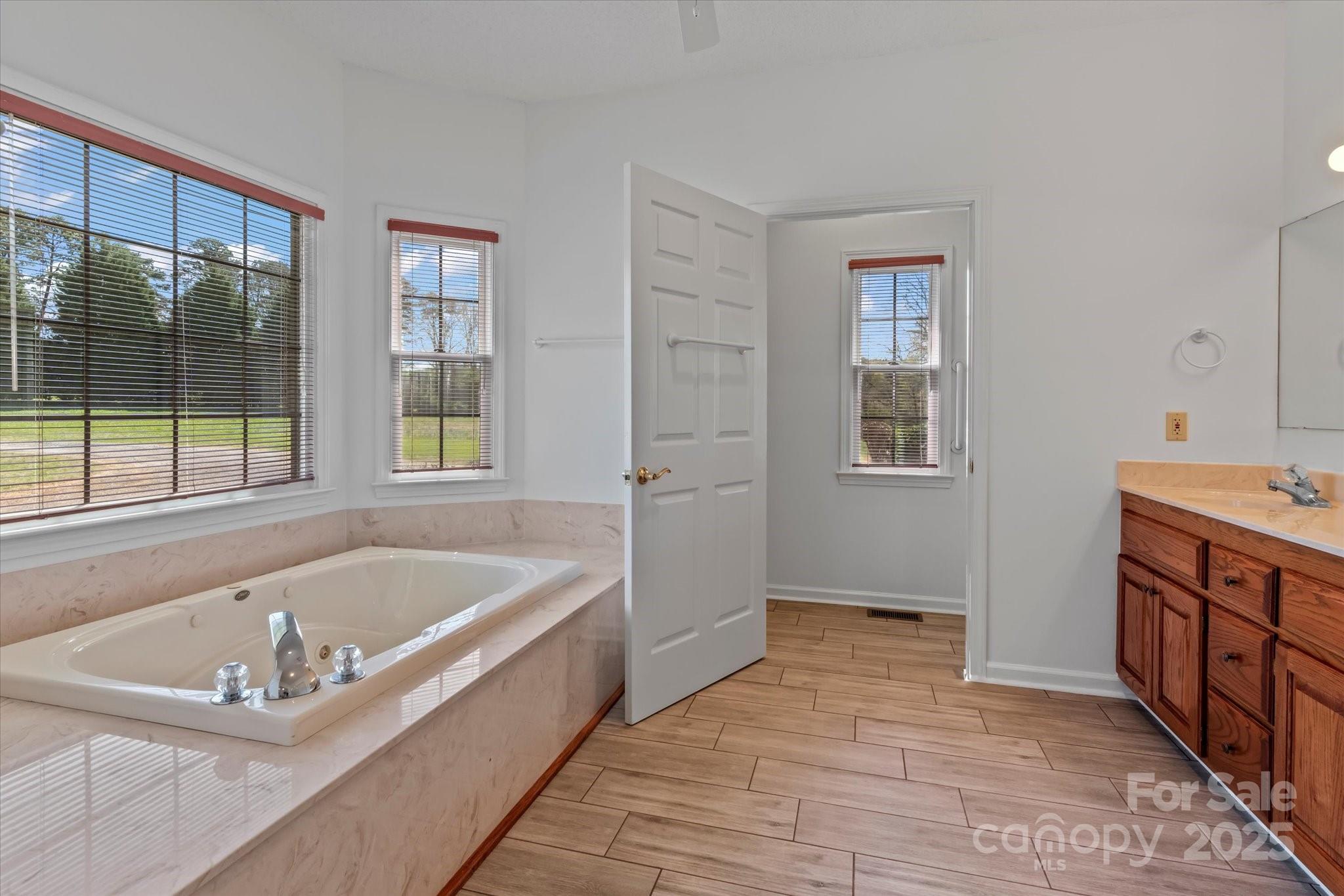 1030 Hurley School Road Salisbury, NC 28147 - Photo 26 of 48 a spacious bathroom with a tub sink and mirror