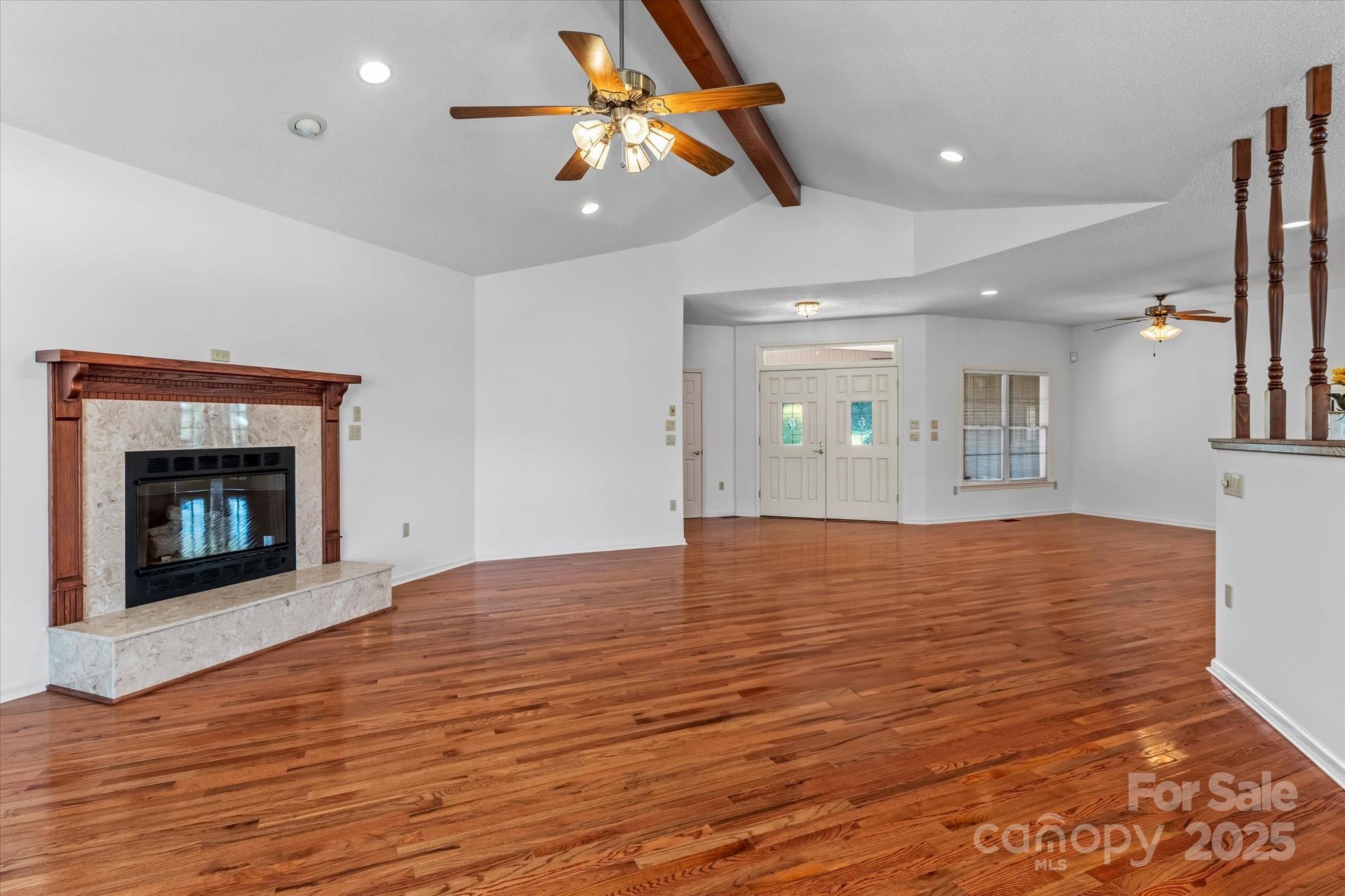 1030 Hurley School Road Salisbury, NC 28147 - Photo 9 of 48 a view of empty room with wooden floor and fireplace