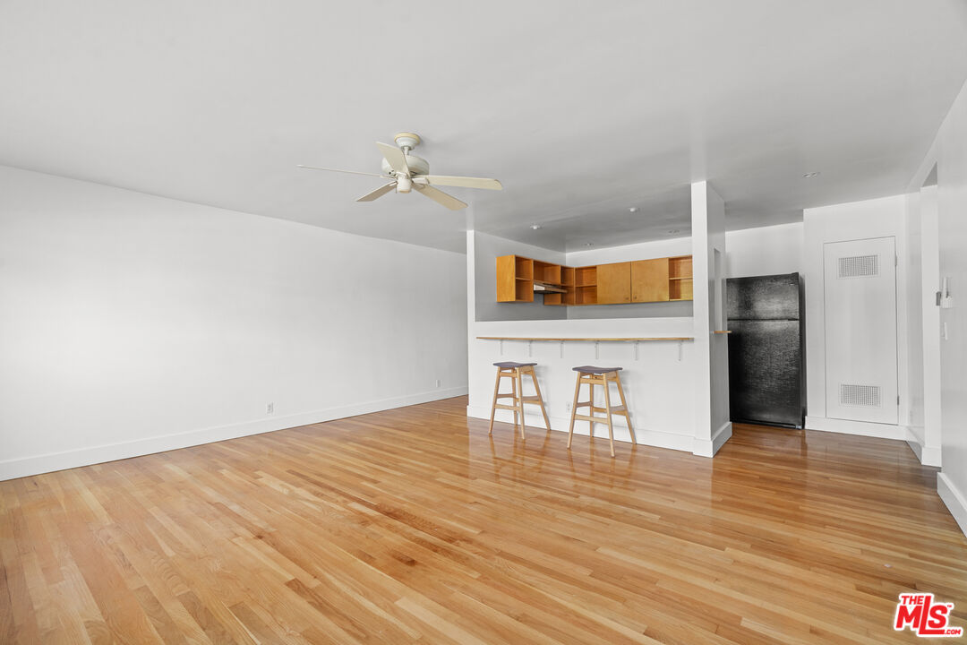 511 Rialto Avenue, Unit 4 Venice, CA 90291 - Photo 2 of 17 a view of a kitchen with wooden floor and a refrigerator