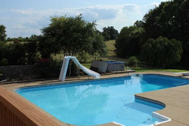259 Martin Road Bon Aqua, TN 37025 - Photo 3 of 20 Fun for the entire family! Pool has heater, slide and diving board. Hot tub is included! The pavilion area has picnic table - a wonderful retreat from the sun! The seller has plumbed one side of the area for an outside kitchen (electrical