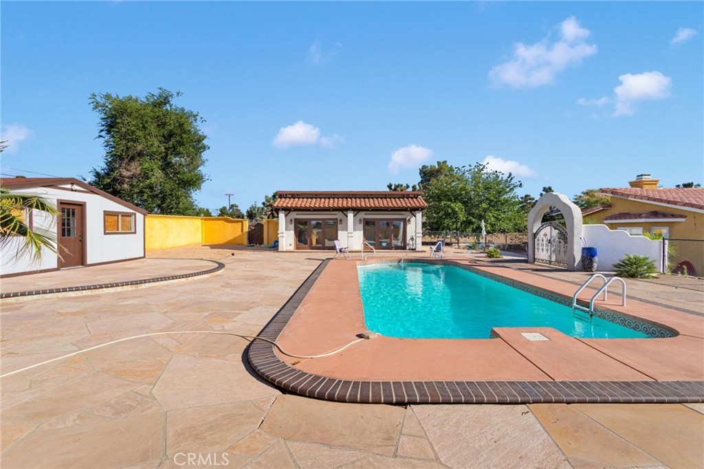 a house with swimming pool in front of it