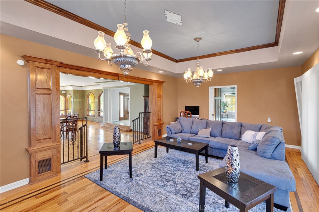 15023 Genesee Road Apple Valley, CA 92307 - Photo 13 of 61 a living room with furniture a chandelier and a dining table