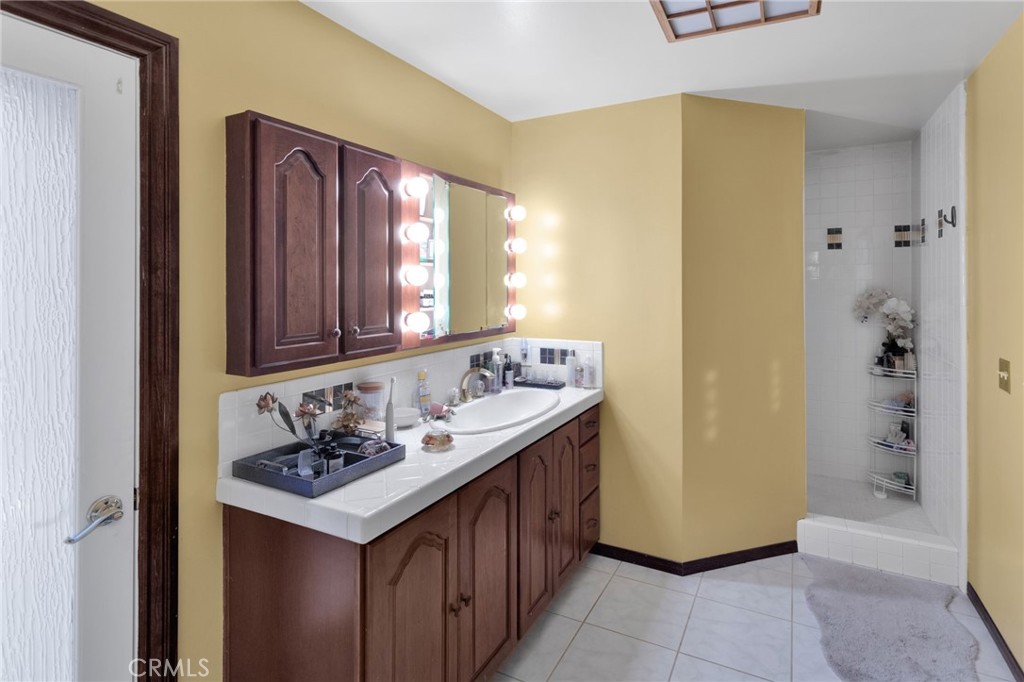 15023 Genesee Road Apple Valley, CA 92307 - Photo 19 of 61 a bathroom with a sink a vanity and a mirror