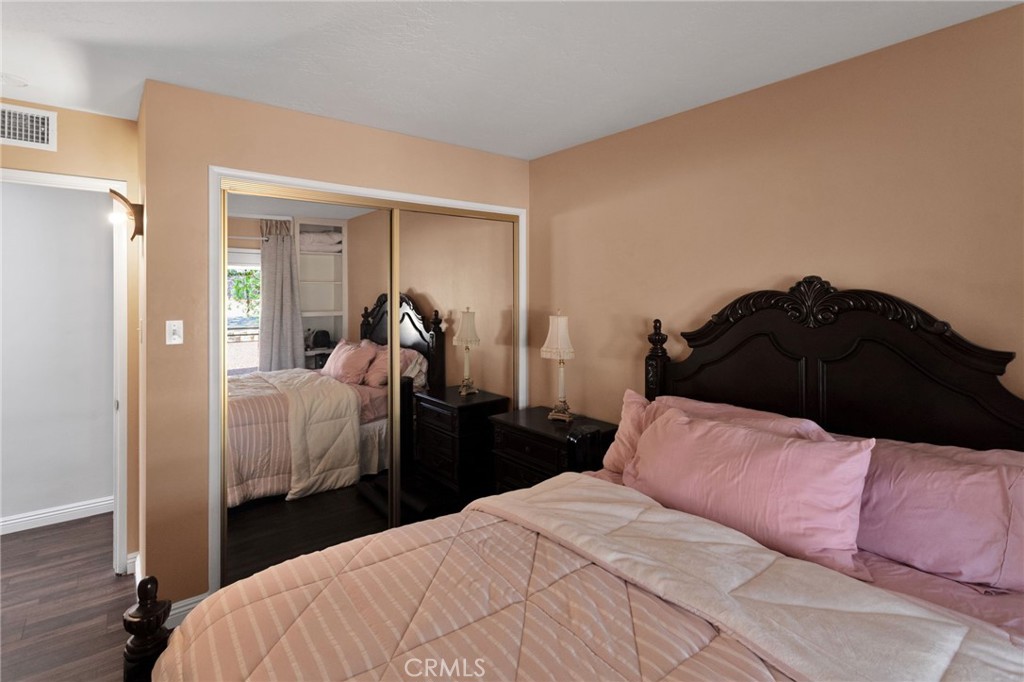 15023 Genesee Road Apple Valley, CA 92307 - Photo 23 of 61 a bedroom with a bed window and walk in closet