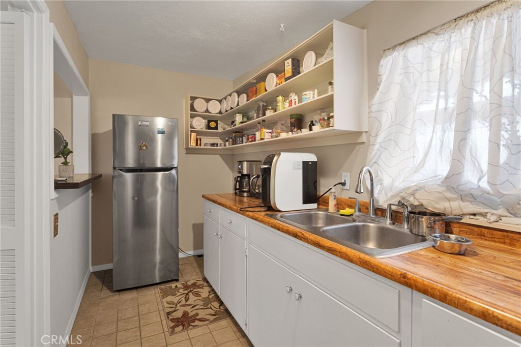 15023 Genesee Road Apple Valley, CA 92307 - Photo 29 of 61 a kitchen with stainless steel appliances granite countertop a refrigerator and a sink
