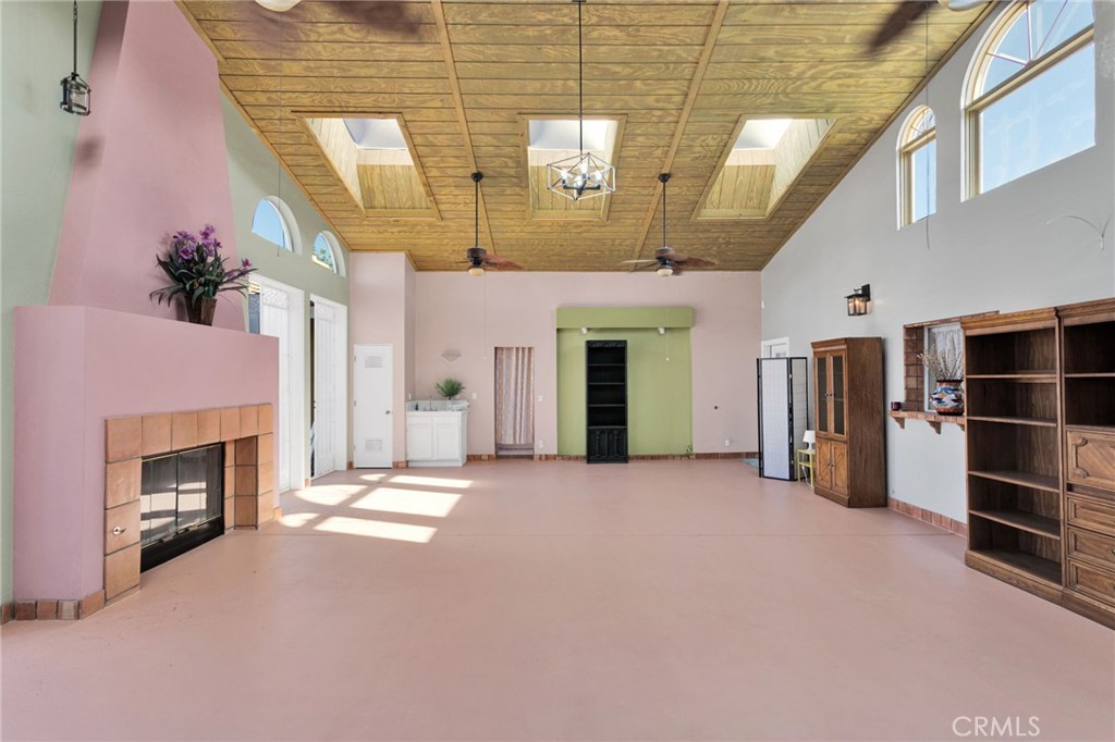15023 Genesee Road Apple Valley, CA 92307 - Photo 36 of 61 a view of an empty room with a fireplace and a window